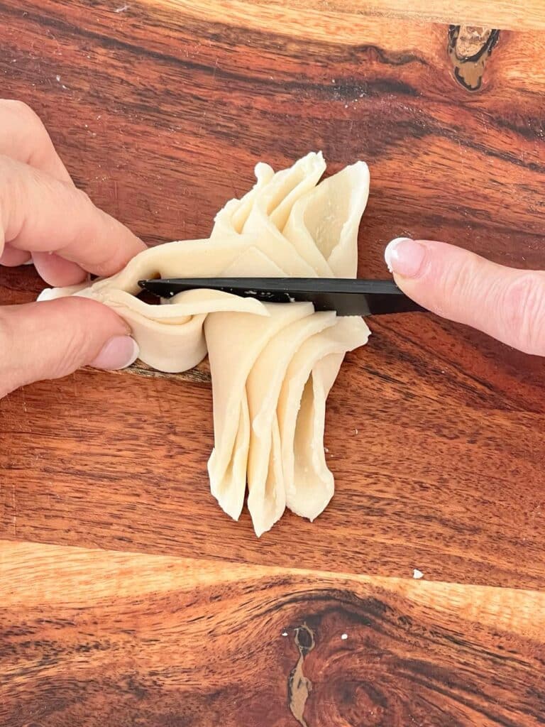 fall cookie recipe: Folding and pinching the first pastry quarter.