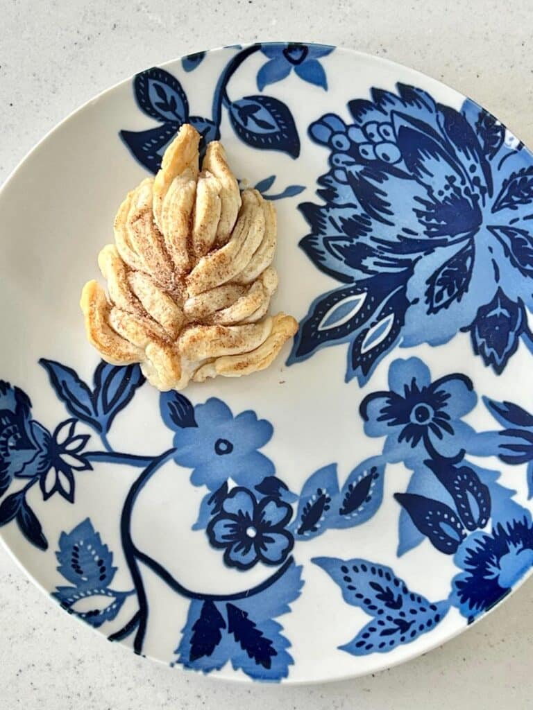 A 3D leaf cookie on a blue and white plate.