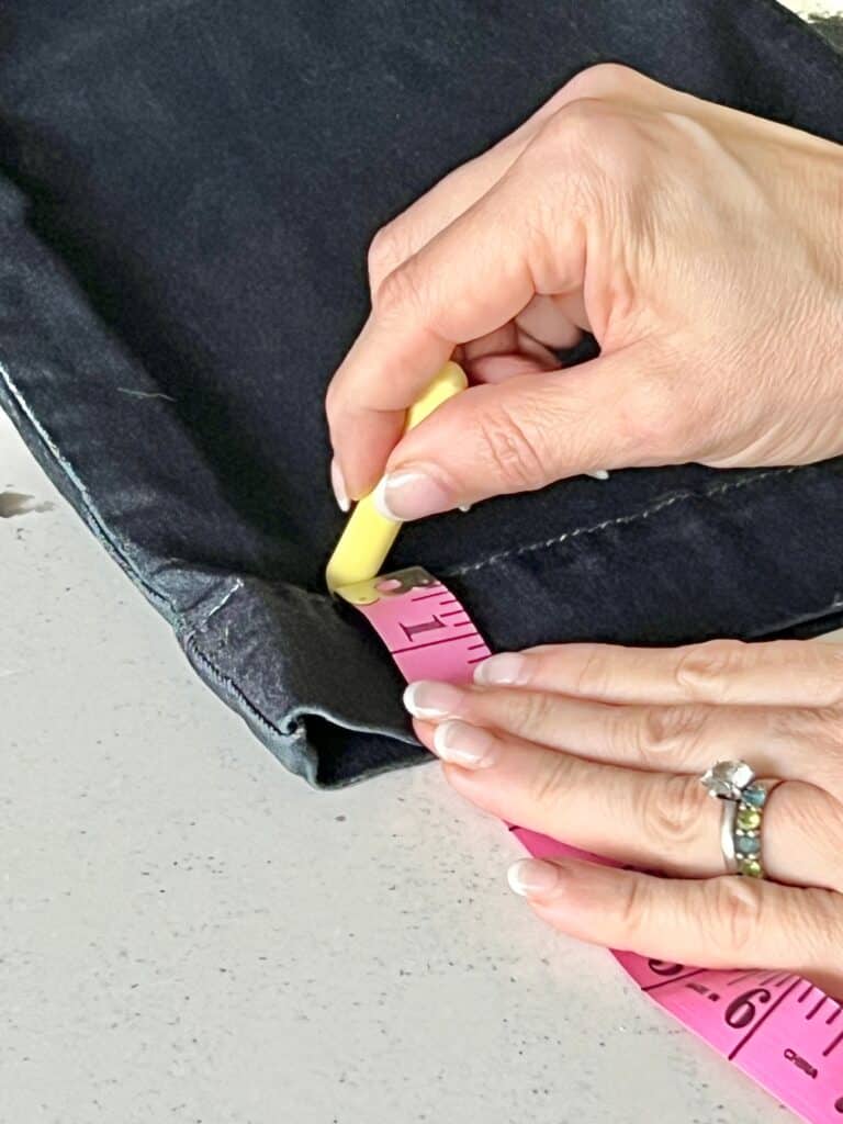 Marking the hem of jeans with chalk.