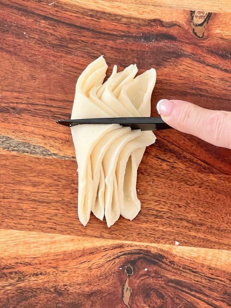 fall cookie recipe: Semi-slicing the stacked pastry quarters with a plastic knife.