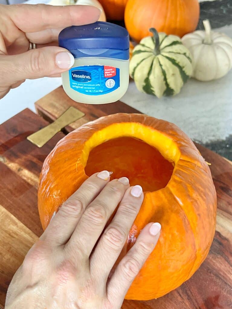 Rubbing petroleum jelly on the edge of the pumpkin hole.