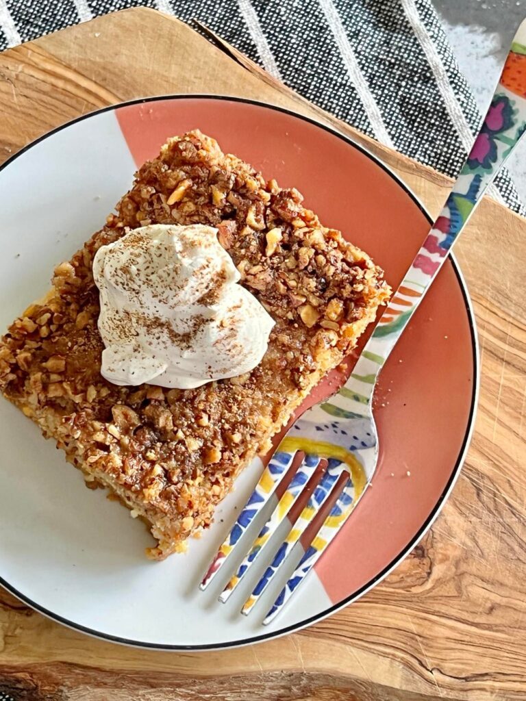 recipe for pumpkin pie crunch cake plated with a fork.