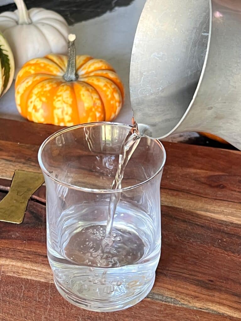 Pouring water in aa glass vase.