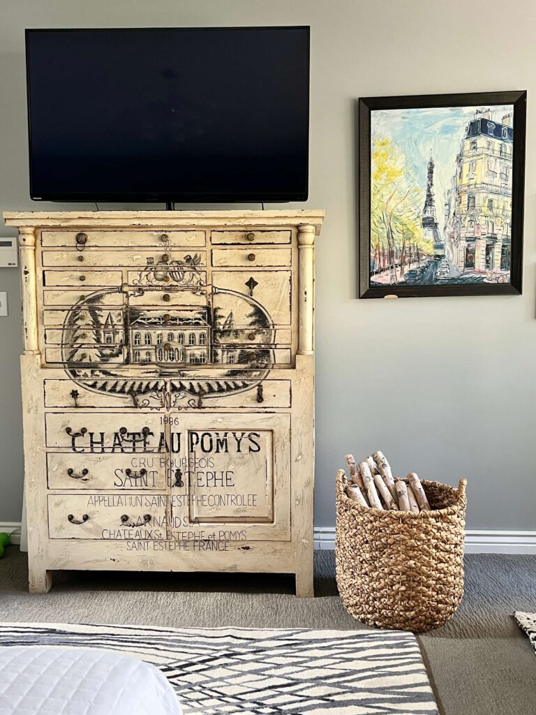 A printers chest with a tv on top of it.