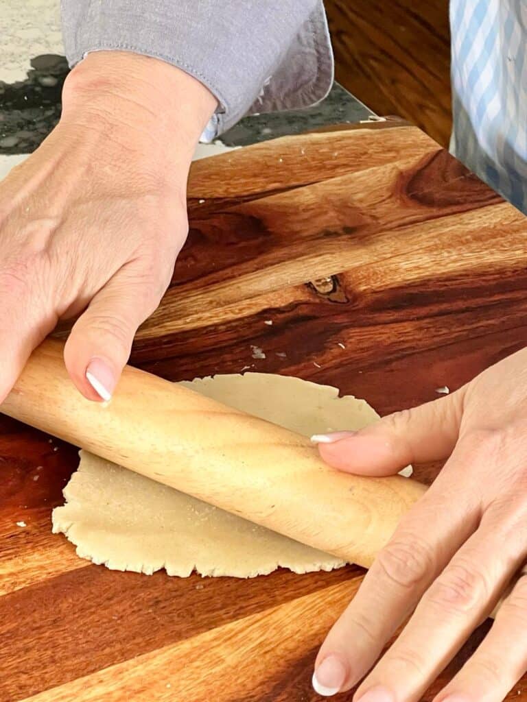 Rolling out sugar cookie dough.