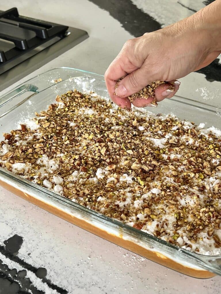 recipe for pumpkin pie crunch cake: Sprinkling pecans on top. of the dry cake mix.