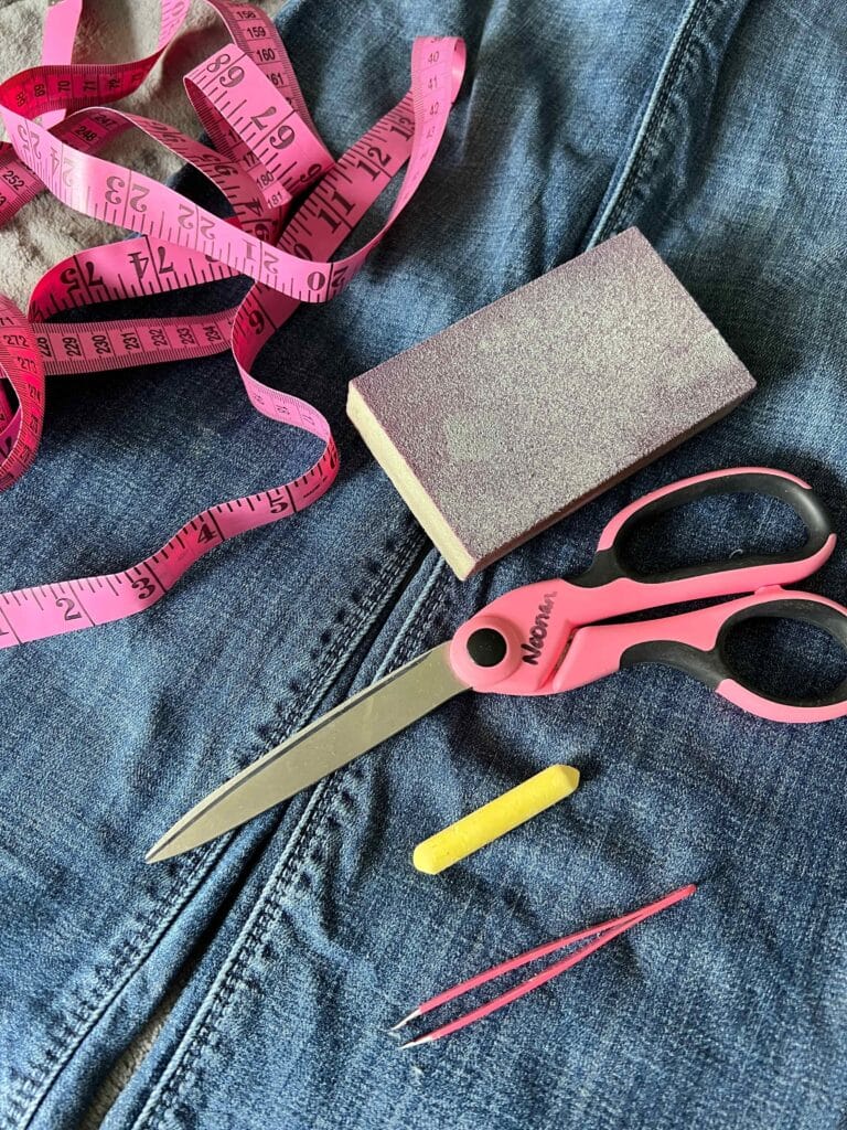 The supplies need fo knowing how to fray jeans include scissors, chalk, and sandpaper.