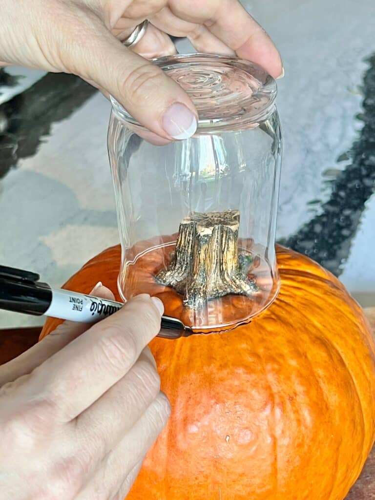 Tracing around a glass vase to create pumpkin floral arrangements.