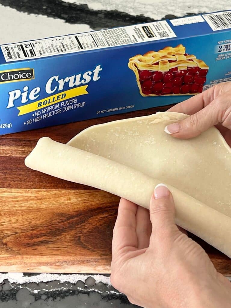 Unrolling refrigerated pie crust.