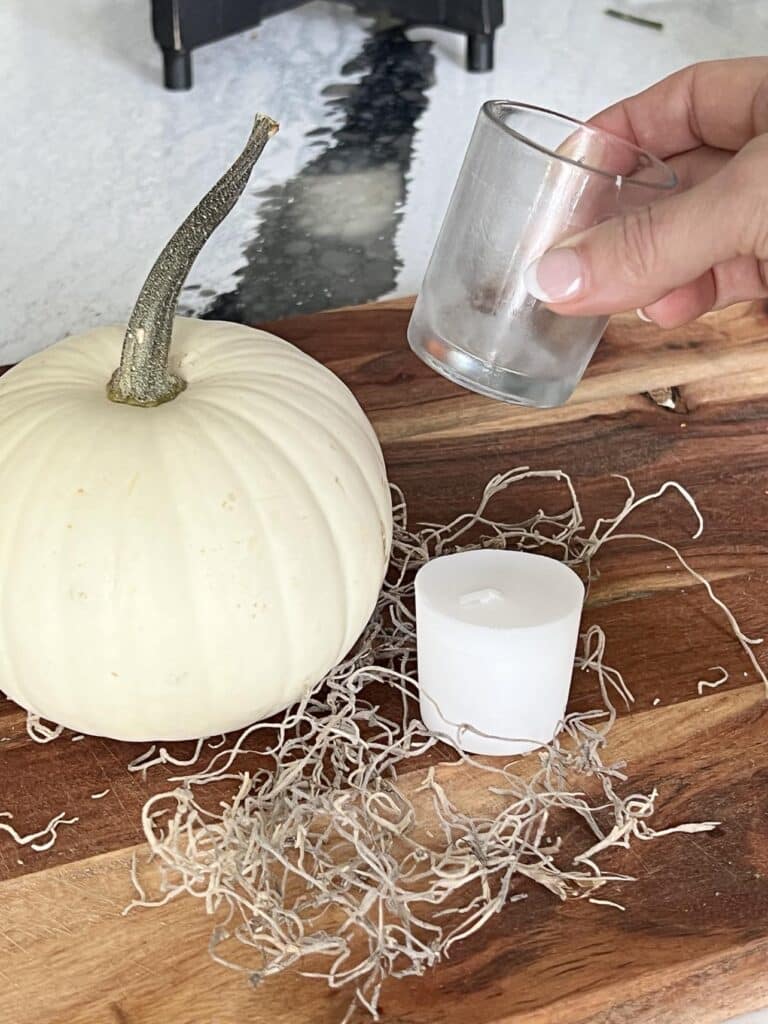 A white pumpkin and a small glass votive candle holder for pumpkin floral aarrangements.