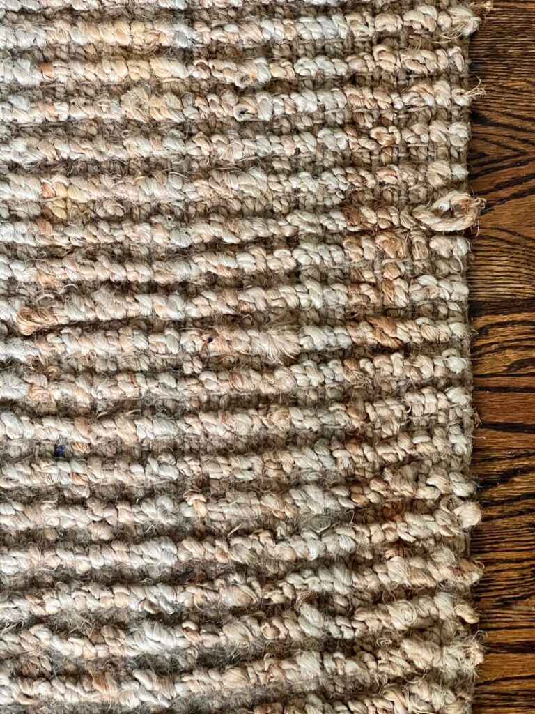 The woven fibers of a floor jute rug.