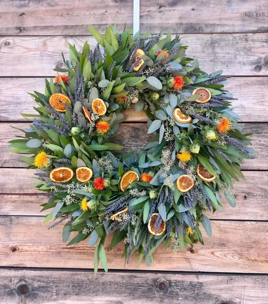 A eucalyptus wreath with dried oranges and lavender.