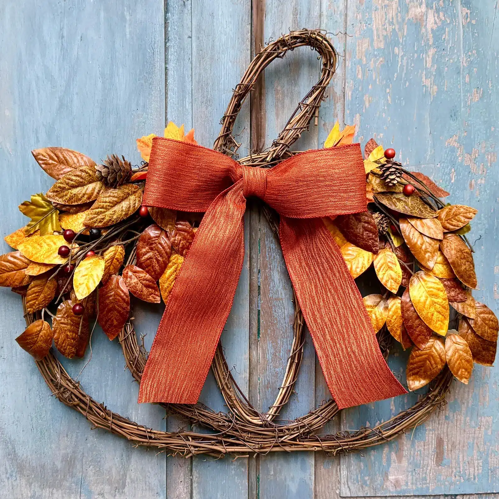 A grapevine pumpkin fall wreath for the front door.