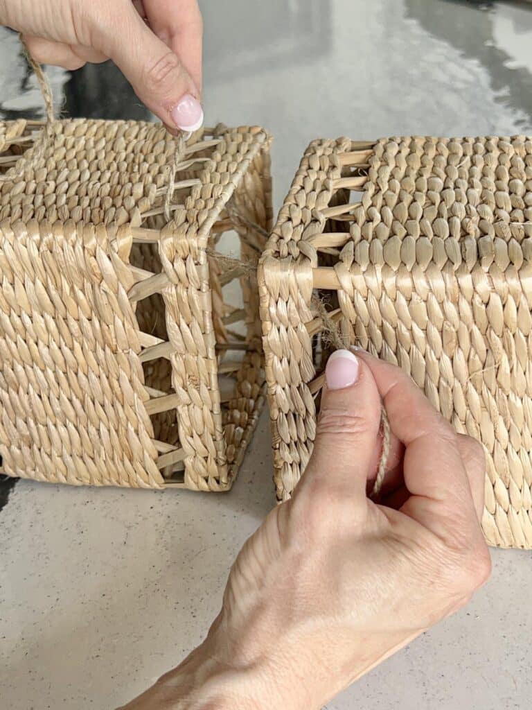 Connecting two tissue boxes at the corners with jute twine.