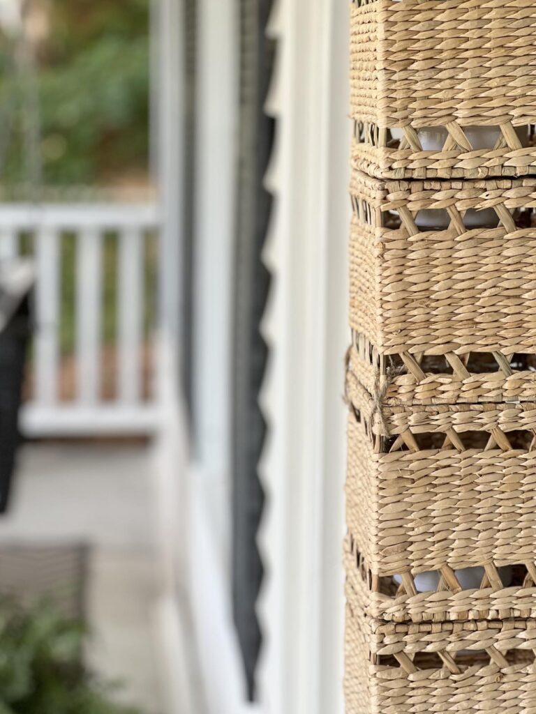 A DIY wireless wall sconce hanging on a porch door.