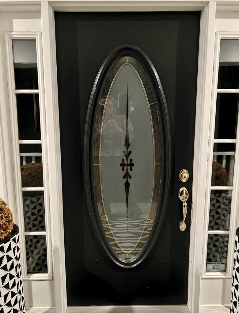 A front door within oval glass insert that will get a DIY decor makeover.