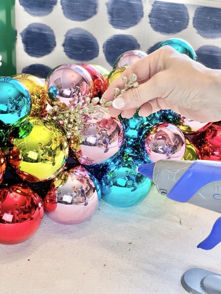Christmas ball ornaments ideas: Gluing metallic picks to a centerpiece.