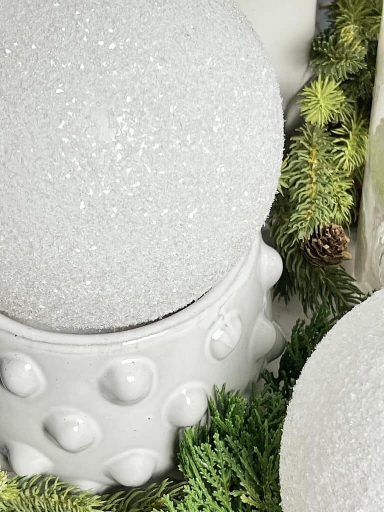 diy faux snowballs displayed with evergreens.