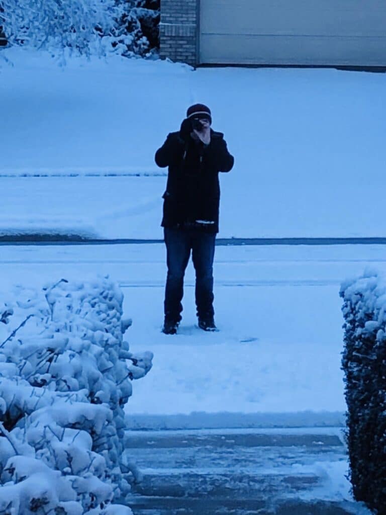 Brian taking an early morning photo of new snowfall.