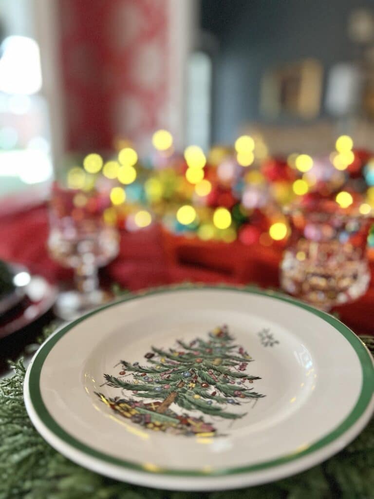 A Spode Christmas plate is a table setting idea to place in front of Christmas ball ornaments centerpiece.
