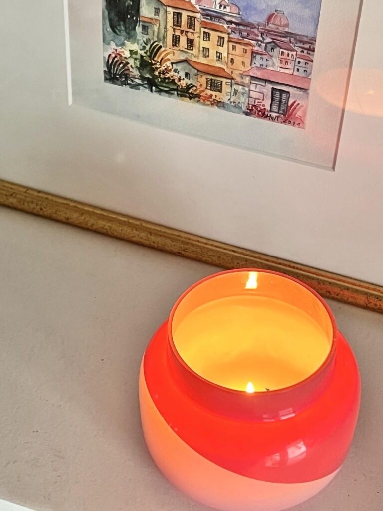 
A lighted pink candle jar.