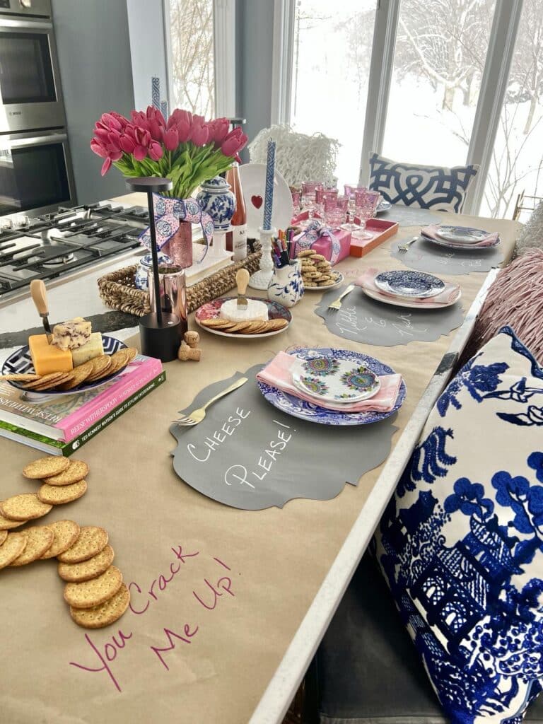 DIY valentine table decorations that include hand written placemats and decorated paper table runner.