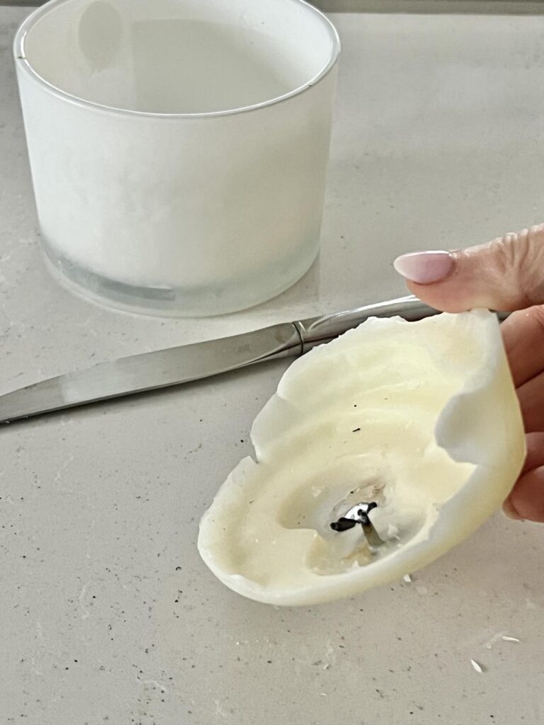 How to clean a candle jar: Use a knife to pry frozen wax from the jar.