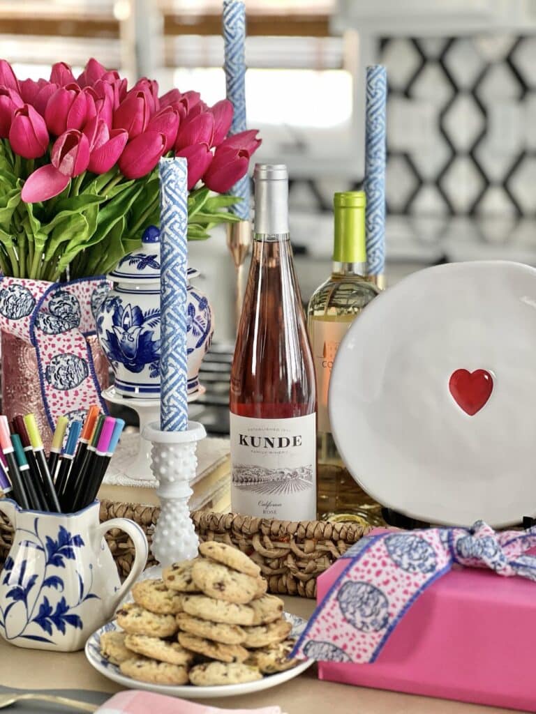 A DIY centerpiece with aa pitcher full of pencils so guests can draw valentines messages as table decorations.
