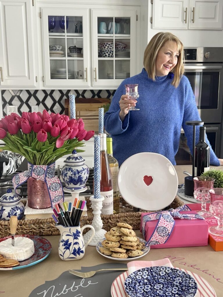 Missy standing in front of tthe "Nibble and Nosh" tablescape.