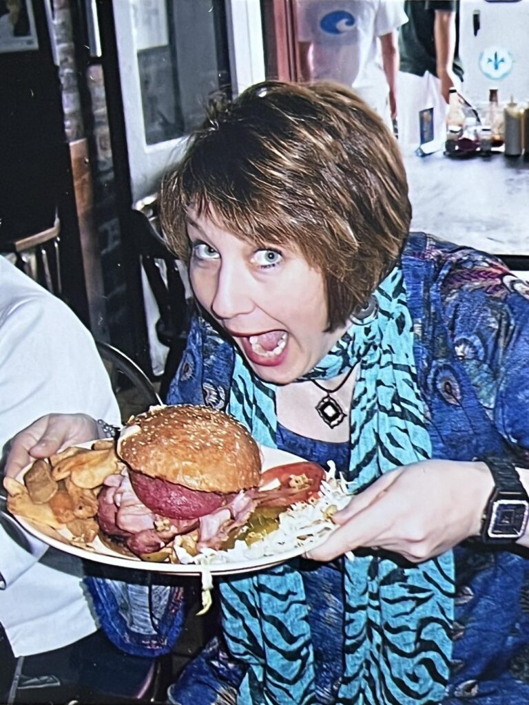 Missy trying to eat a huge muffuletta saandwich.