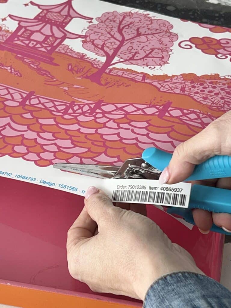 Trimming a piece of wallpaper.