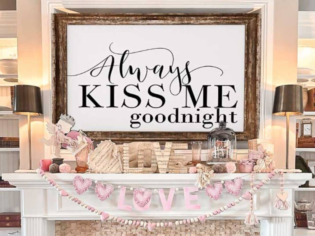 A large sign above a fireplace that says "always kiss me goodnight"