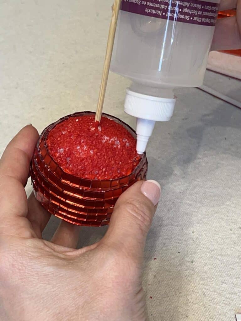 Securing tiles with glue on the styrofoam ball.