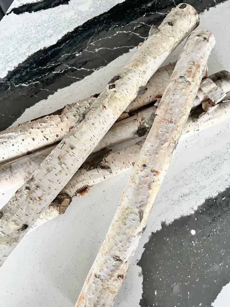 A pile of birch logs used for a DIY project. 