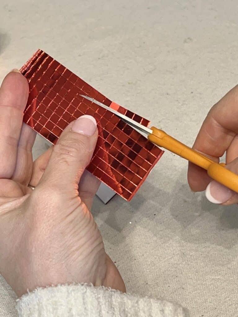 Cutting strips of ribbon tile for DIY Disco Ball Cherries.