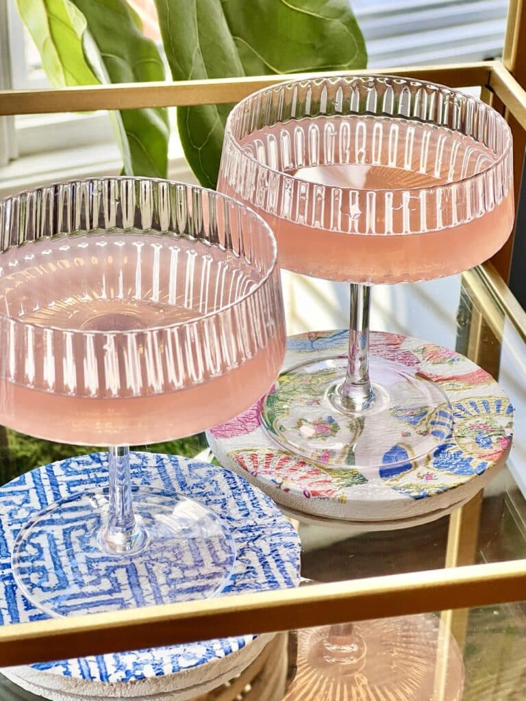 Cocktails glasses on DIY decoupage coasters covered with differently patterned paper napkins.
