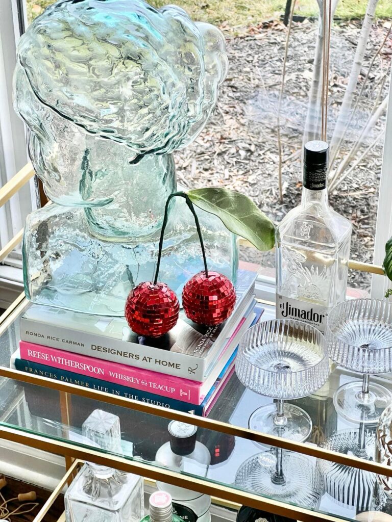 The DIY Disco Ball Cherries displayed on a bar cart.