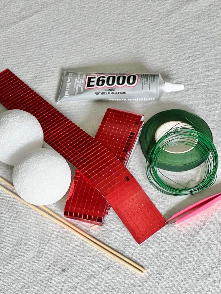 Supplies for DIY Disco Ball Cherries that include ribbon, styrofoam balls and floral tape.