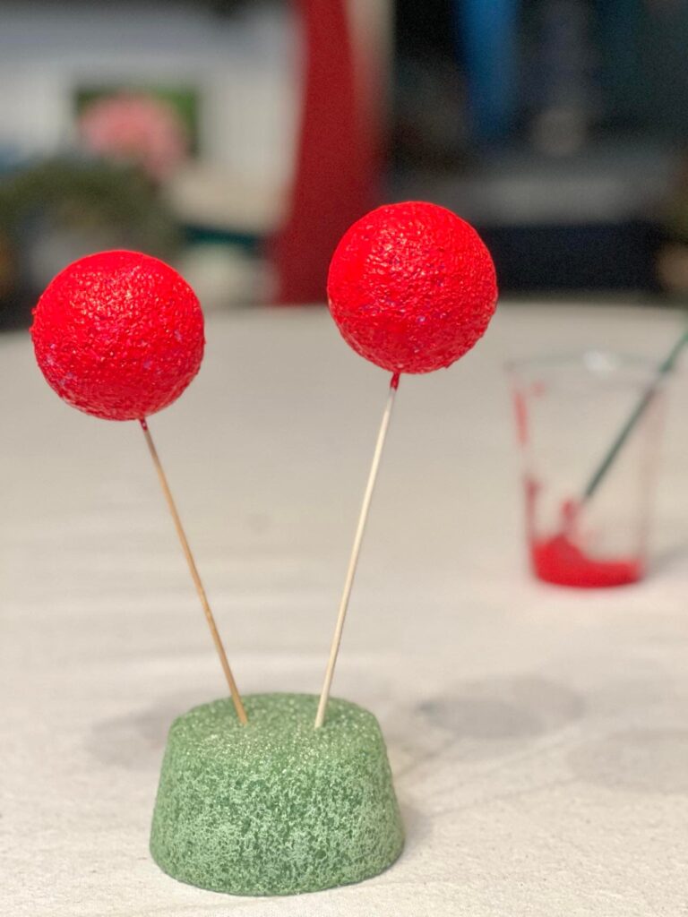 Painted styrofoam balls that are drying.