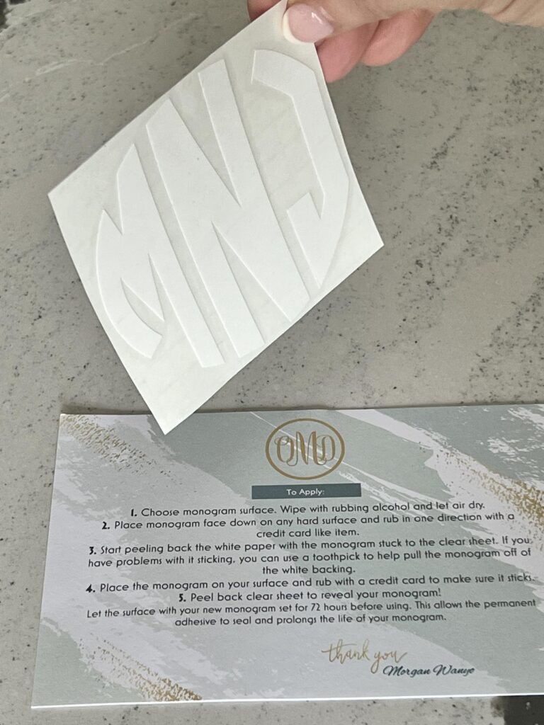 A white monogram stickers with the letter MNJ.