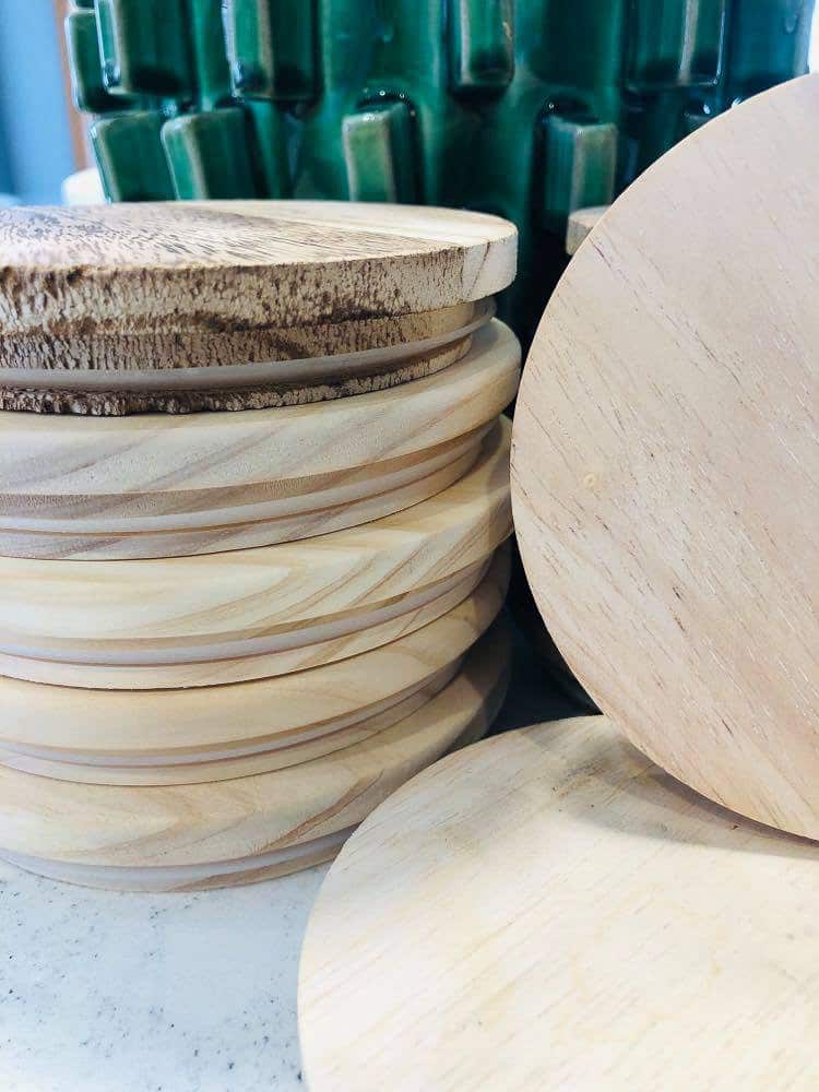A stack of wood lids from candle jars.