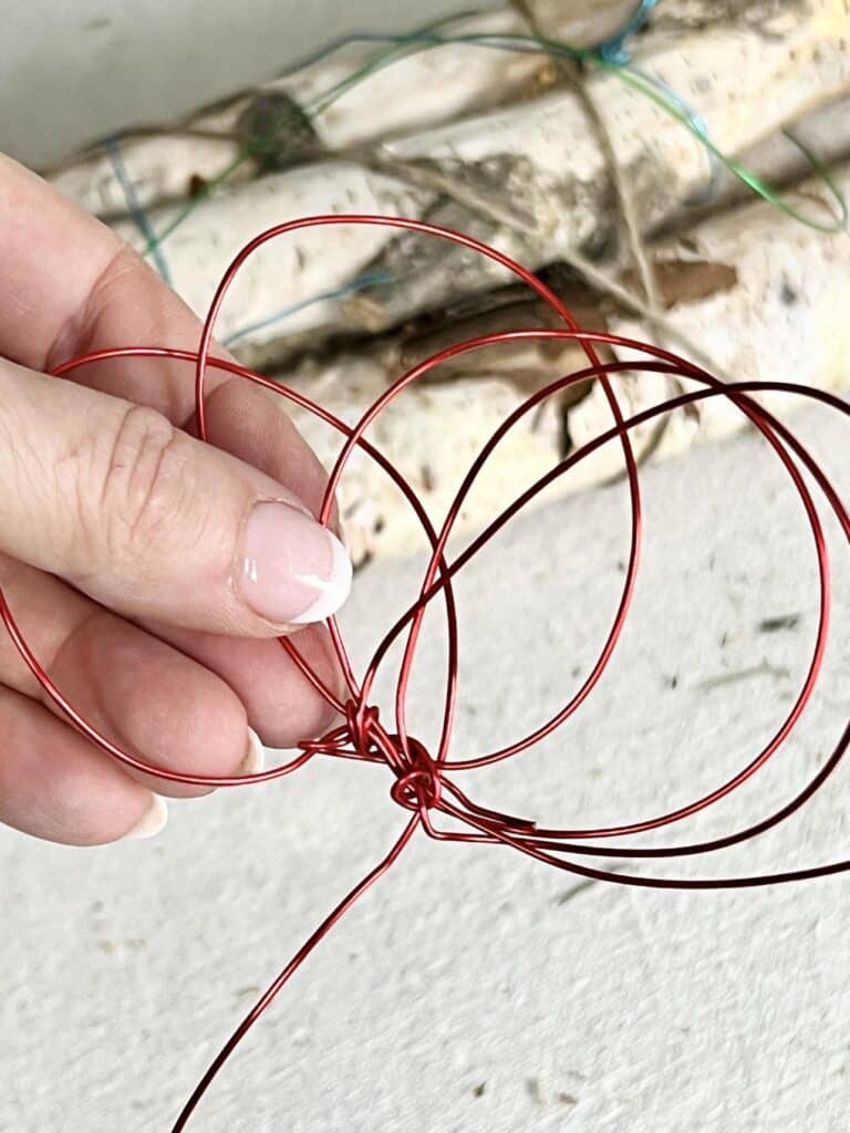 red wire loops twisted into a flower shape.
