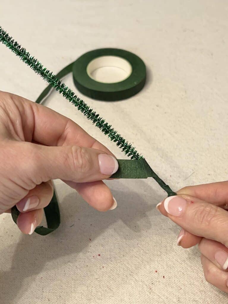 Wrapping a pipe cleaner with floral tape.