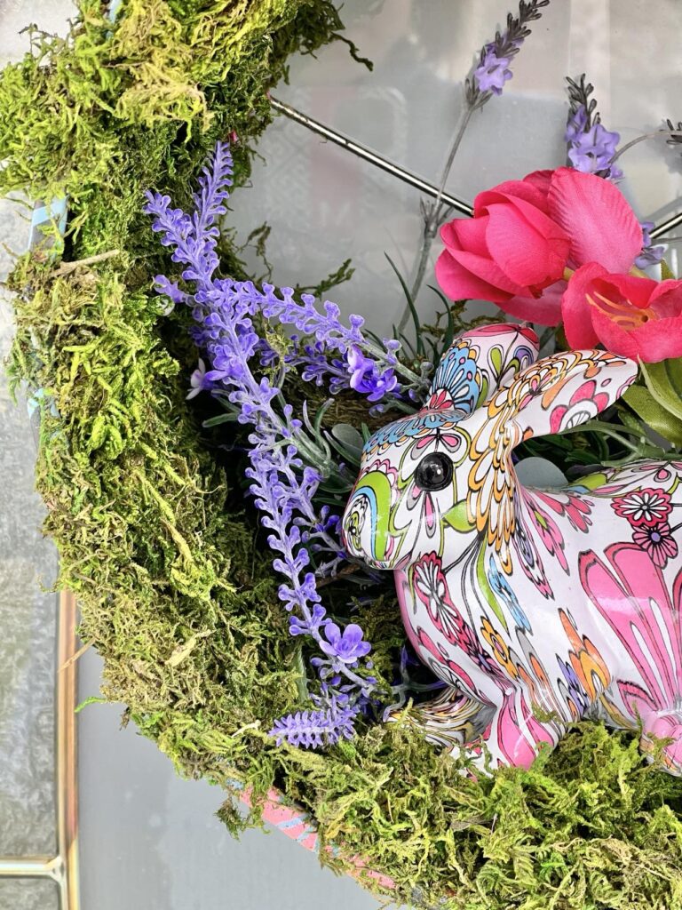 A DIY Door Wreath with a colorful bunny in the center.