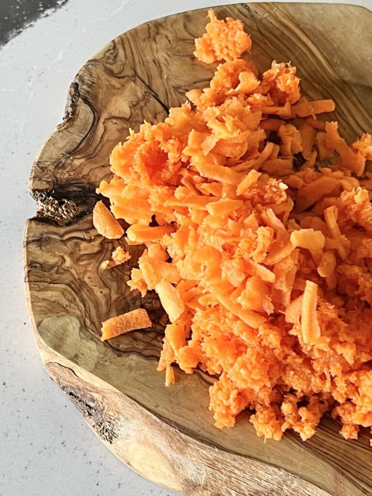 Grated carrots on a cutting board.