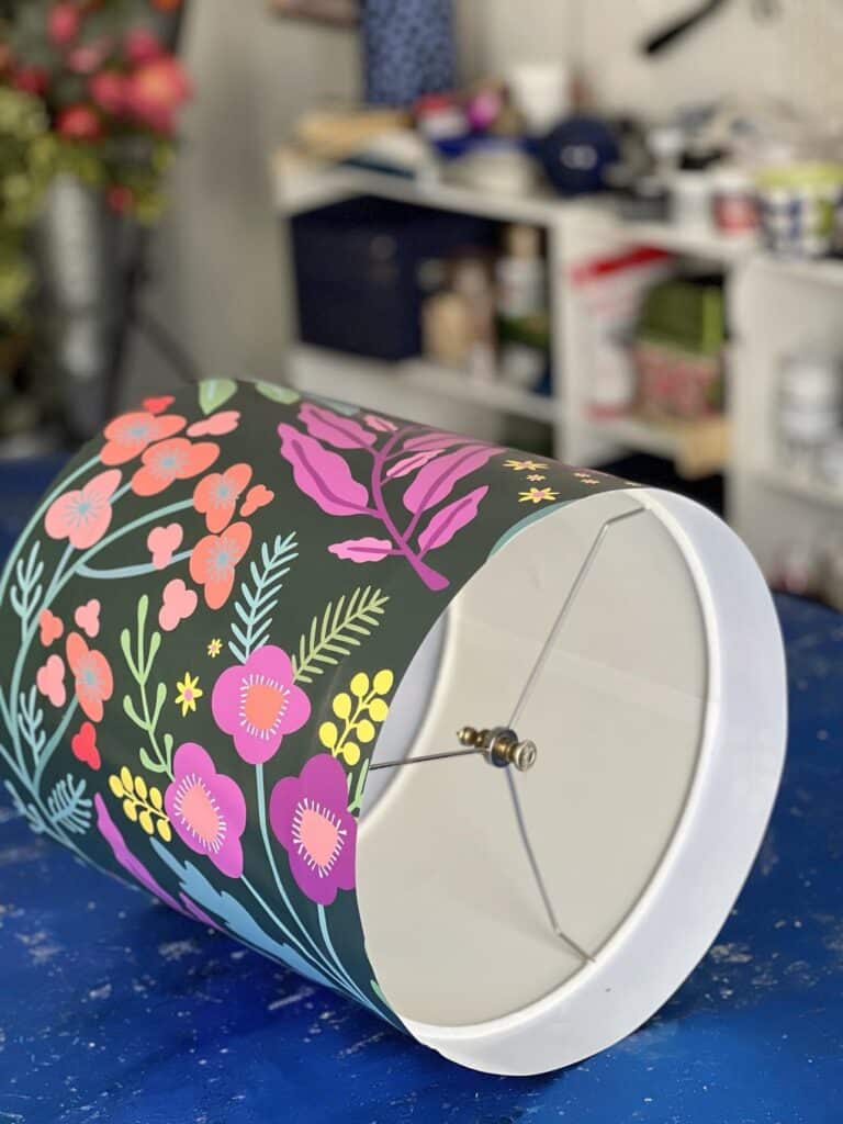 A wallpaper covered lampshade for DIY Door Wreath.
