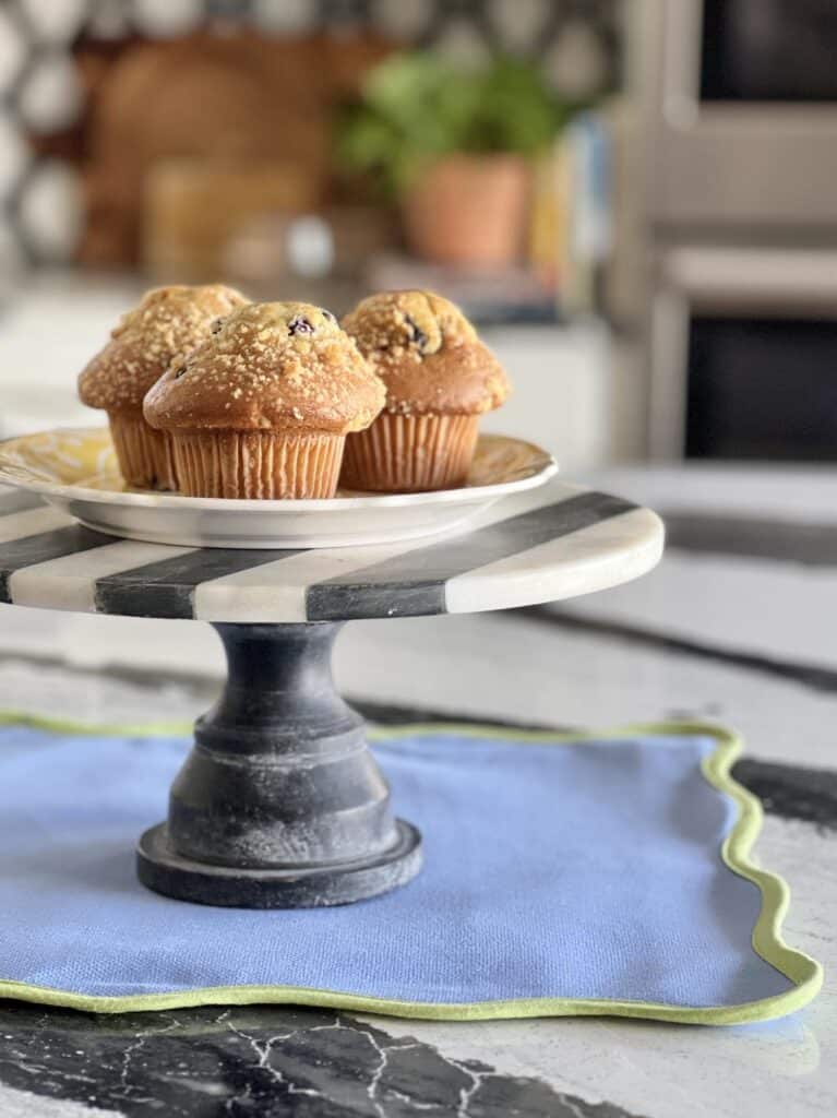 A cake stand on a kitchen island to decorate the counter space.