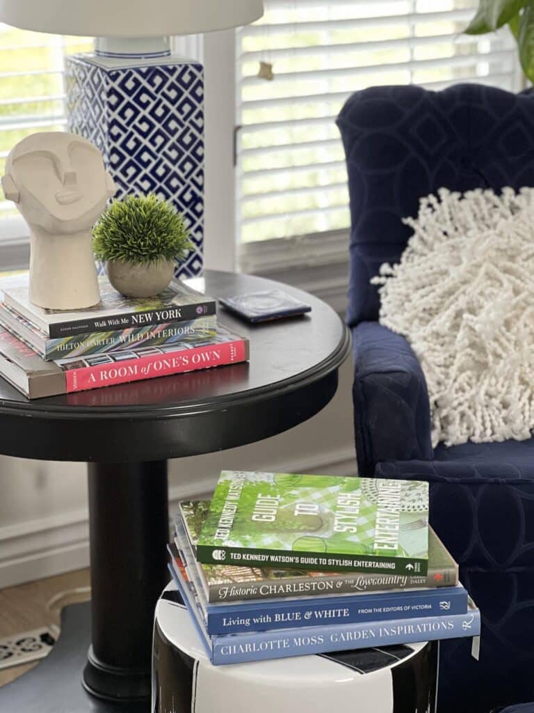 A black side table beside a reading chair: reading nook ideas bedroom