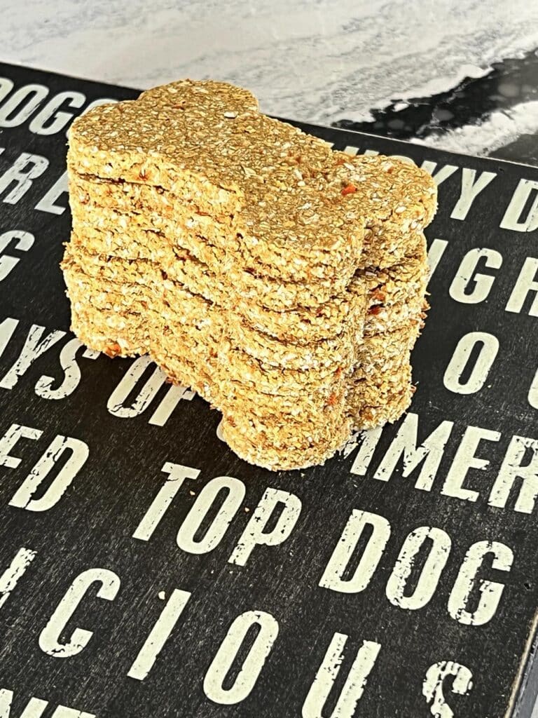 A stack of bone-shaped homemade oatmeal dog treats.