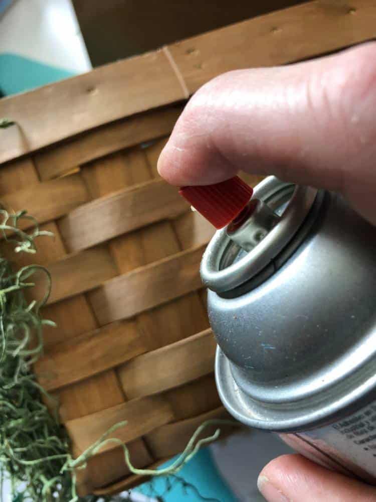 Spraying the side of a basket for how to make a may day basket.